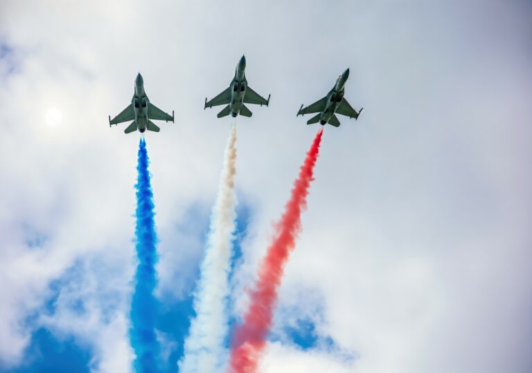 Three fighters in a harsh form, leaving red, white and blue smoke of the flag of france