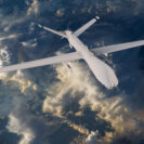 Military rc military drone flies flies against backdrop of beautiful clouds on blue sky background. elements of this image furnished by nasa