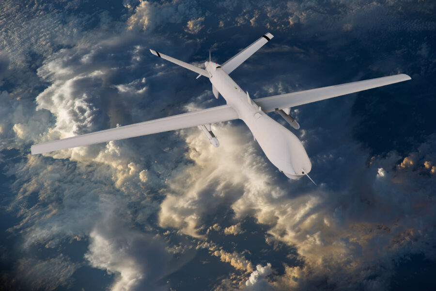 Military rc military drone flies flies against backdrop of beautiful clouds on blue sky background. elements of this image furnished by nasa